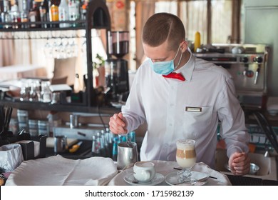The Waiter Works In A Restaurant In A Medical Mask