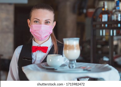 The Waiter Works In A Restaurant In A Medical Mask