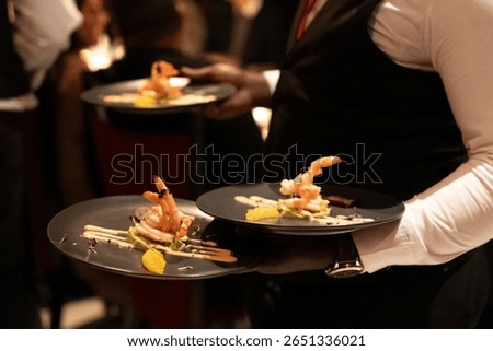Waiters serving entrees in a restuarant