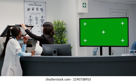 Waiting Area And Reception Desk With Greenscreen On Tv Display, Hospital Lobby In Facility. Chroma Key Copyspace With Isolated Mockup Background And Blank Template On Monitor, Healthcare.