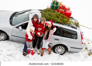 Waiting For Christmas  - The Family Is Carrying  Christmas Tree And Gifts On The Roof Of The Car