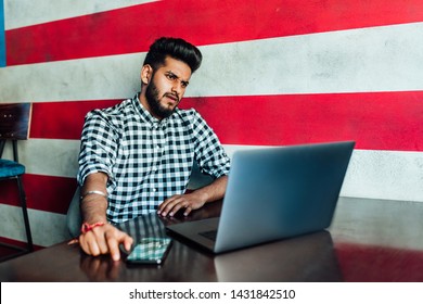 Waiting For The First Customer. Cheerful Young African Man Looking At Camera With  While  Using Laptop..