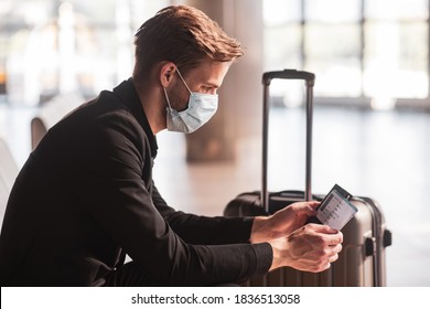 Waiting For A Flight. A Man Wearing A Face Mask While Waiting For A Flight