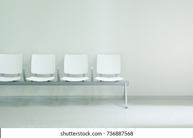 Waiting Hall Chairs Forming A Row Against A White Wall Background. Empty Copy Space For Editor's Text.