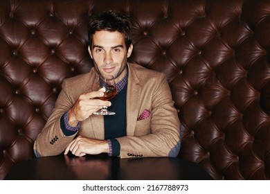 Waiting for my friends. Portrait of a handsome young man drinking in a club. - Shutterstock ID 2167788973