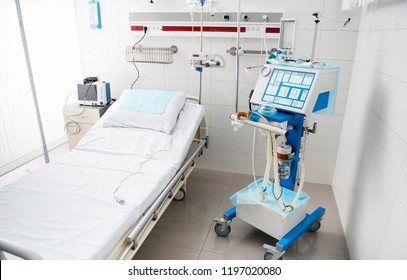 Waiting For Patients. Modern And Fully Equipped Recovery Room In White Tones With Bed, Mechanical Ventilator And Digital Device For Measuring Blood Pressure