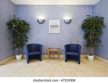 Waiting Room With Blue Armchairs And Plants