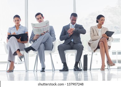 Waiting Room With Business People Sat In Line