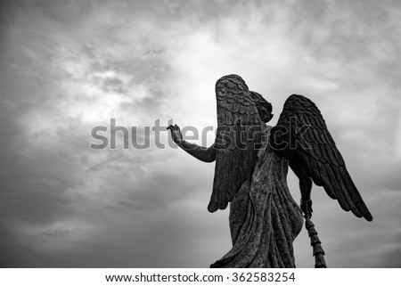Waiting for some one, Angel statue hold her hand  to the sky. Black and white photography
