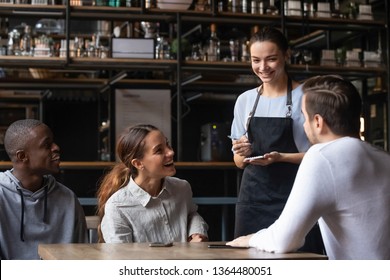 Waiting staff in apron holds notepad ready take order restaurant visitors advises dishes and drinks to diverse cheerful friends, restaurant business, eating outside the home weekend activities concept