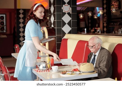 Waitress attending to elderly man in retro diner, involving delivering meal and handing menu, with classic decor. Portrait of waitress looking straight at camera - Powered by Shutterstock