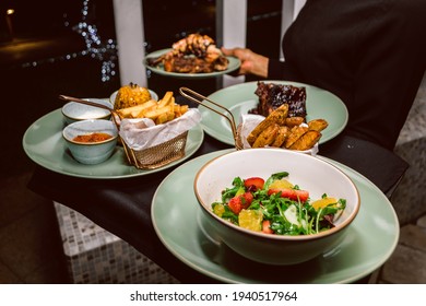 Waitress Carrying A Customer’s Food Order In A Luxury Restaurant In Lagos - A Waitress In A Posh Restaurant 