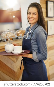 Waitress In Coffee Shop Holding Tray