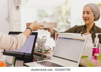 Waitress Giving Customer Takeaway Food Box In Restaurant.