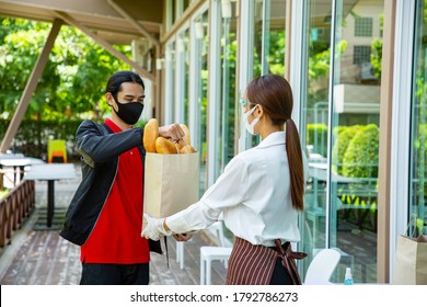 Waitress Holding Bread Food Paper Bag To Delivery Boy For Send To Customer.Take Away Order.Thai People Takeout Food From Restaurant.