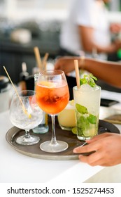 Waitress Holds Tray Of Luxury Cocktails Ready For Serve At Beach Bar. 