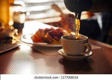 Waitress Pouring Fresh Coffee At A Classic Breakfast Diner