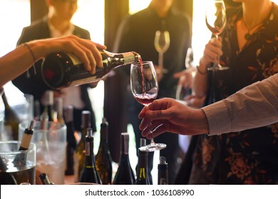 The waitress was pouring a glass of wine. In celebration of the team's success. - Shutterstock ID 1036108990