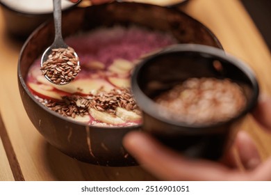 Waitress prepares a healthy breakfast with pitaya or dragon fruit smoothie, natural yogurt, seeds and cereals, apple and banana. Concept of healthy life, health. - Powered by Shutterstock