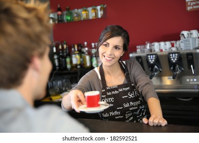 Waitress Serving Coffee From Machine