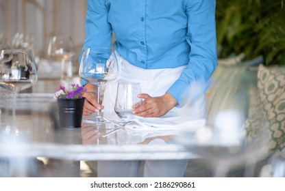 Waitress Serving The Empty Table Of The Luxury Restaurant