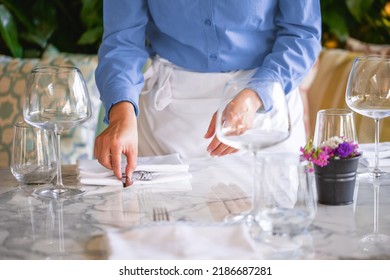 Waitress Serving The Empty Table Of The Luxury Restaurant