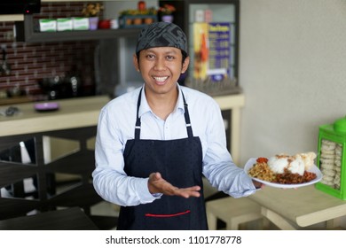 Waitress Serving Food Nasi Lemak. Asian Man Using Waitress Apron For Work With Holding Nasi Lemak. Yogyakarta Indonesia. May 31, 2018