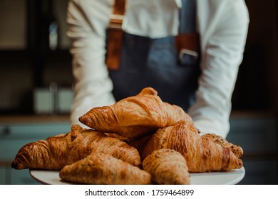 Waitress serving a range of croissants - Powered by Shutterstock