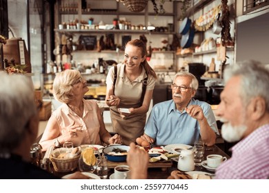 Waitress serving senior friends enjoying breakfast in a cozy cafe - Powered by Shutterstock