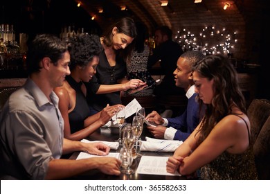 Waitress Takes Order In Restaurant Using Digital Tablet