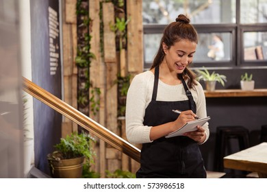 A waitress is taking the order in a coffee shop