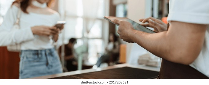 Waitress use digital tablet take order service customer at coffee shop. SME business coffee shop concept. - Powered by Shutterstock