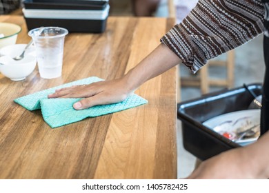 The waitress wipes the table in restaurant. Close up of woman hand cleaning table with wet wipe. - Powered by Shutterstock