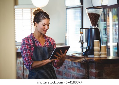 Waitress writing in a book in a cafe - Powered by Shutterstock