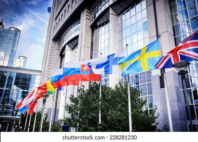 Waiving flags in front of European Parliament building. Brussels, Belgium