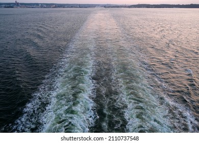 Wake After Ship Goes Out To Sea At Sunset.