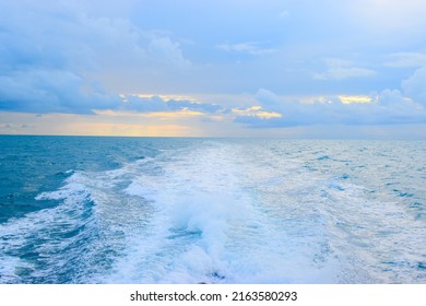 The Wake From A Boat At Sea During Sunset