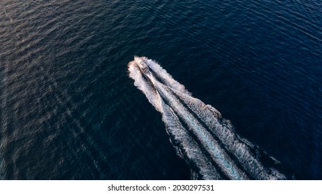 Wake Of A Boat At Sunset