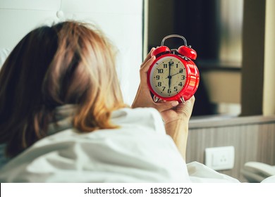 Wake Up Call.Woman Waking Up And Turning Off The Alarm Clock Having A Good Day