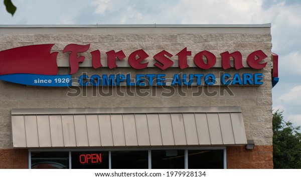 Wake Forest, NC- United\
States- 05-24-2021: The exterior of a Firestone Auto center with\
signage. 