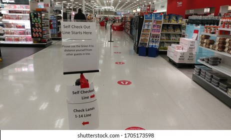 Wake Forest, NC/United States- 04/15/2020: Signage At The Self Checkout Line Along With Floor Markings Instructs Customers To Practice Social Distancing At A Target.