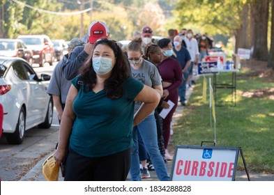 Wake Forest, NC/United States- 10/15/2020: A lady wearing a face mask is amongst a diverse group of voters on the first day of early voting. 