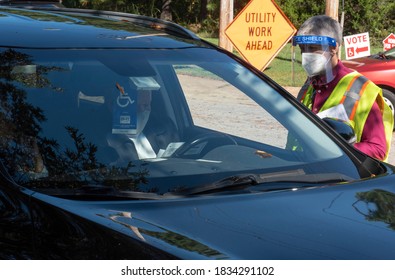 Wake Forest, NC/United States- 10/15/2020: A Poll Worker Assists An Elderly Man At A Curbside Voting Location.