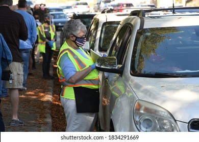 Wake Forest, NC/United States- 10/15/2020: A Poll Worker Assists A Pair Of Voters At A Curbside Voting Location.