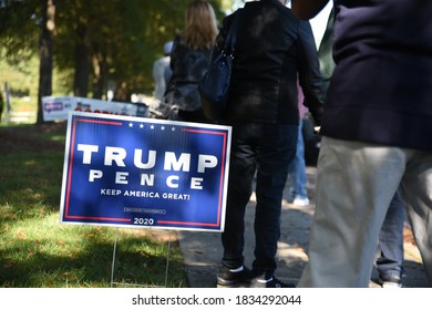 Wake Forest, NC/United States- 10/15/2020: Voters walk past a Trump sign as they wait to cast ballots on the first day of early voting. 