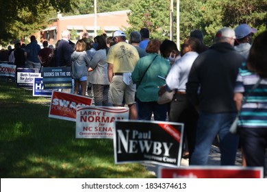 Wake Forest, NC/United States- 10/15/2020: NC Voters wait in long lines to cast their ballots on the first day of early voting. 