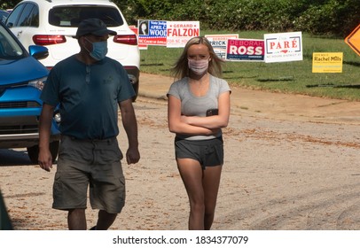 Wake Forest, NC/United States- 10/15/2020: An Attractive Young Woman And Her Father Walk Towards A Polling Location For Early Voting. 