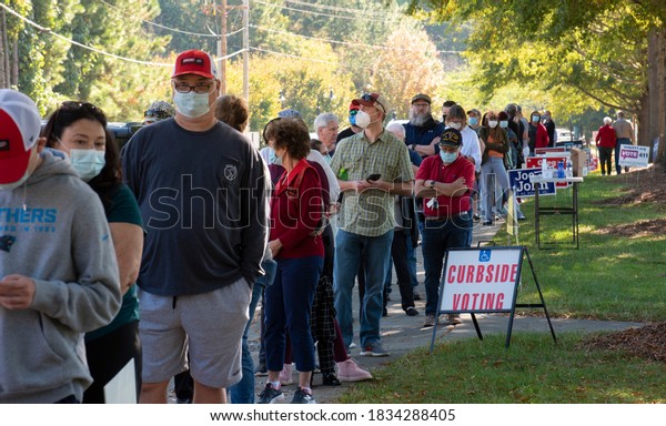 Wake Forest, NC/United States- 10/15/2020: North\
Carolina voters stand in very long lines to cast their ballots on\
the first day of early\
voting.