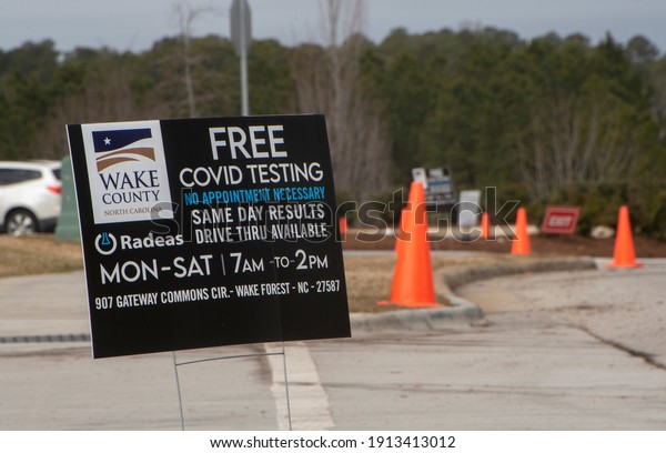 Wake Forest, North Carolina- United States-\
02-09-2021: A COVID testing sign is displayed in front of a drive\
thru clinic in Wake\
Forest.