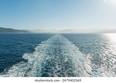 A wake line behind a boat from the ship's deck. - Powered by Shutterstock